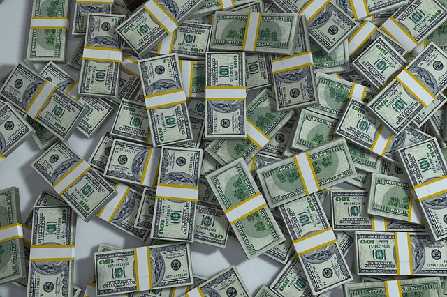 An image of piles of stacks o 100 dollar bills.